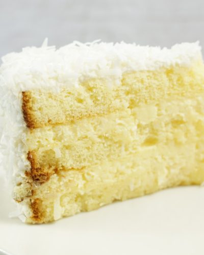 savor the classic flavor of a traditional coconut cake slice at Mia's Bakery.
