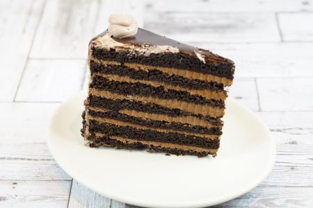 savor the classic flavor of a traditional chocolate layer cake slice at Mia's Bakery.