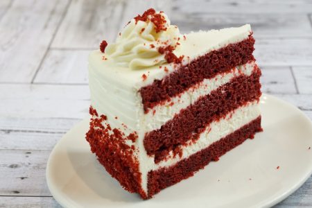 savor the classic flavor of a traditional red velvet cake slice at Mia's Bakery.