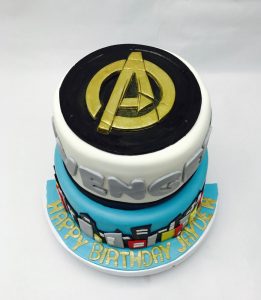 Custom two-tier Avengers birthday cake with gold logo and superhero fondant decorations, Mia's Brooklyn Bakery NYC