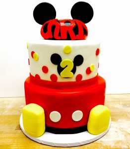 Custom two-tier Mickey Mouse second birthday cake with red and yellow fondant decoration, Mia's Brooklyn Bakery NYC