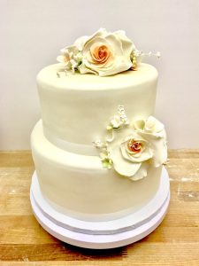 Two-tier ivory fondant wedding cake with sugar rose decorations, Mia's Brooklyn Bakery NYC