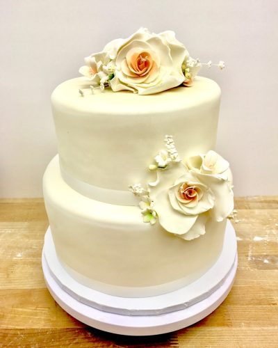 Two-tier ivory fondant wedding cake with sugar rose decorations, Mia's Brooklyn Bakery NYC