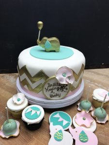 Custom baby shower cake with gold elephant topper, cupcakes, cake pops, and decorated cookies, Mia's Brooklyn Bakery NYC