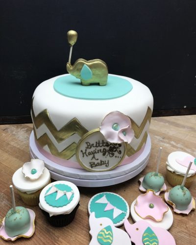 Custom baby shower cake with gold elephant topper, cupcakes, cake pops, and decorated cookies, Mia's Brooklyn Bakery NYC