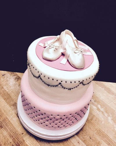 Custom two-tier pink fondant birthday cake with ballet shoe topper and pearl decorations, Mia's Brooklyn Bakery NYC