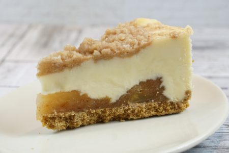 savor the classic flavor of a traditional New York style apple cheesecake slice at Mia's Bakery.