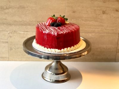 Chocolate raspberry cake with red glaze and fresh strawberries and blackberries, Mia's Brooklyn Bakery NYC