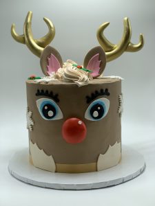 Christmas Rudolph reindeer cake with gold antlers, red nose, and fondant face decoration, Mia's Brooklyn Bakery NYC