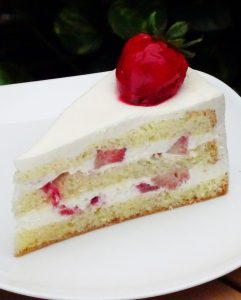 savor the classic flavor of a homemade strawberry shortcake cake slice at Mia's Bakery.