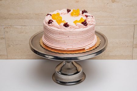 savor the classic flavor of a traditional peach raspberry cake at Mia's Bakery.