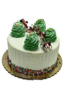 Christmas cake with Santa sleigh topper, green buttercream trees, and reindeer decorations, Mia's Brooklyn Bakery NYC