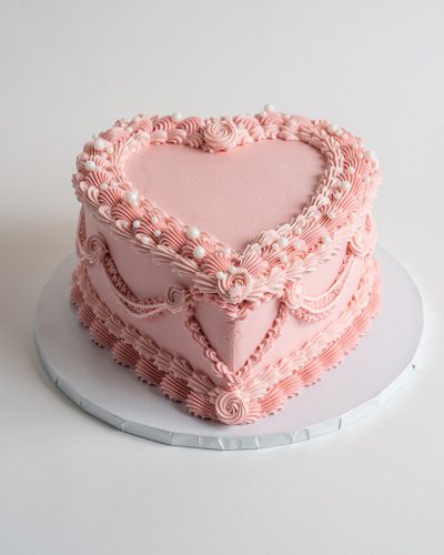 savor the flavor of custom Pink Vintage Heart Cake at Mia's Bakery.