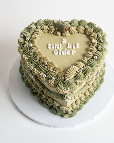 savor the flavor of custom vintage heart cake green at Mia's Bakery.