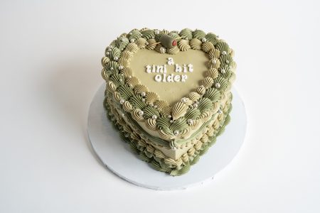 savor the flavor of custom vintage heart cake green at Mia's Bakery.