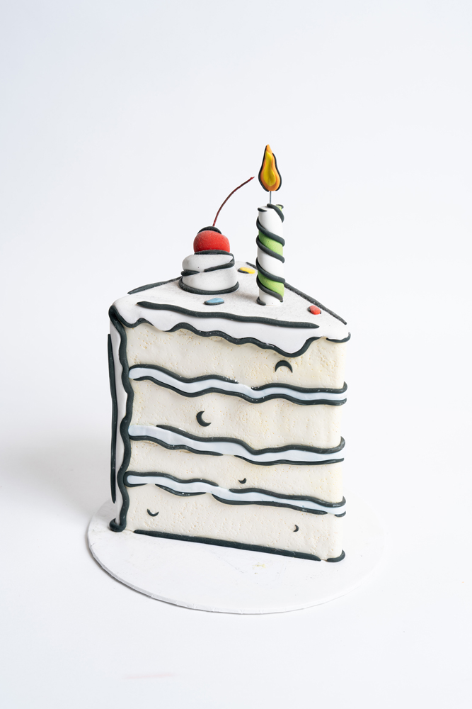 Unique custom cake designed as a cartoon-style slice with cherry and candle, handcrafted by Mia’s Bakery for fun birthday celebrations